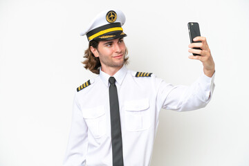 handsome Airplane pilot isolated on white background making a selfie