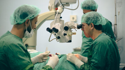 Eye surgery. A patient and surgeon in the operating room during ophthalmic surgery. Patient under...