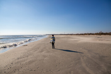 Landscape of a lonely woman walking on a beach