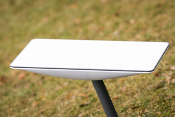 An antenna for receiving the Internet signal from space Starlink on the ground in the park