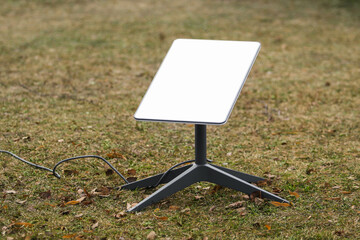 An antenna for receiving the Internet signal from space Starlink on the ground in the park