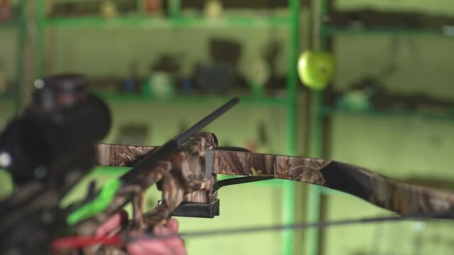 a man takes aim from a crossbow at an apple. High-quality Full HD video recording. live video