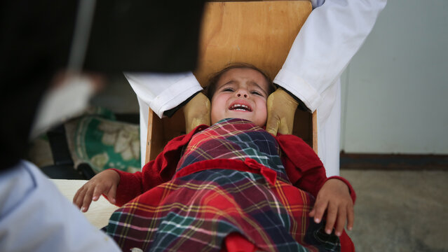Doctor examines child malnutrition. Measuring malnutrition using strap MUAC mid-upper-arm-circumference.	
