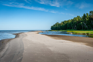 Winding coastline with endless destinations. Shore of the Baltic sea on a sunny day. Ruhnu island, Estonia.