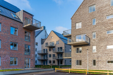 Image of Modern apartments in scandinavian style with brick texture walls and solar panel at the roof