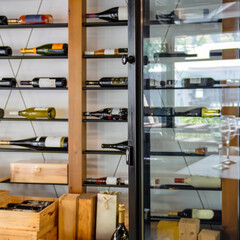 Blurred view of wine storage room with open glass door