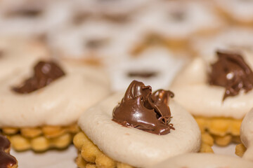 fresh tasty christmas cookies with nougat and white foam macro