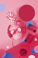 Viva Magenta color of the year 2023. Funny pineapple painted purple on magenta background with various disco circles. Pineapple character in sunglasses and earphones.