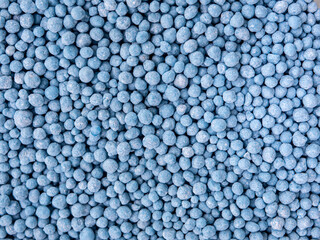 Small blue round granules are chemical fertilizers