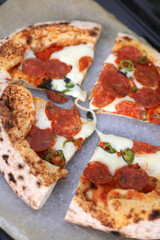 Neapolitan pizza with sausage and jalapeno in the kitchen at home