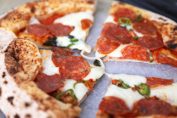 Neapolitan pizza with sausage and jalapeno in the kitchen at home