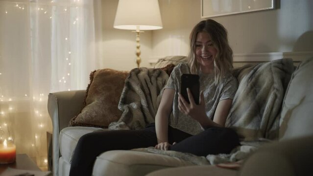 Girl with cell phone nodding head in agreement on video chat / Cedar Hills, Utah, United States