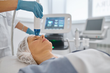 Closeup woman getting cosmetic procedure in beauty salon
