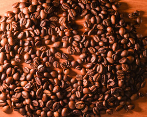 freshly roasted coffee beans for coffee on a coffee machine in a coffee shop on a wooden background