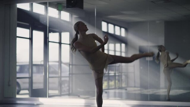 Woman practicing contemporary dancing near mirror in dance studio / Lehi, Utah, United States