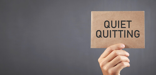 Human showing Quiet Quitting message. Business concept