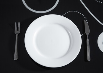 Plate with a fork and knife on the kitchen table.