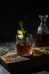 cocktail with whiskey and rasmarino on a dark background