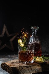 cocktail with whiskey and rasmarino on a dark background