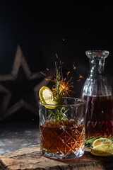 cocktail with whiskey and rasmarino on a dark background