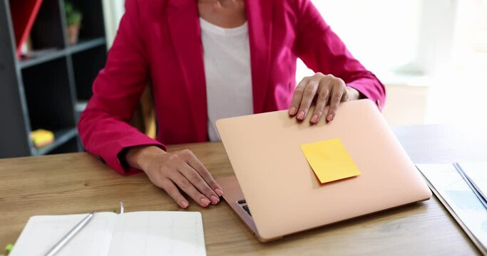 Businesswoman in pink suit opening laptop starting working closeup 4k movie slow motion