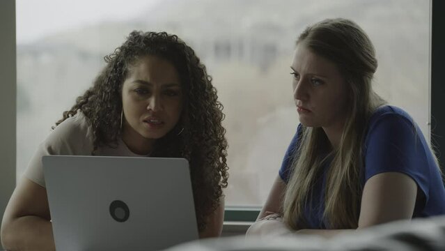 Businesswomen working together using laptop / Provo, Utah, United States