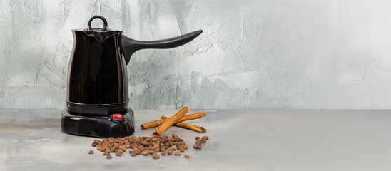 Electric coffee maker for making Turkish coffee. coffee pot, coffee beans and cinnamon sticks