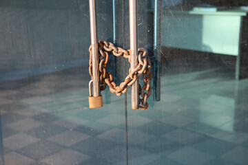 There is a lock on the office door. Rusty chain on glass door and lock on it, bankrupt or closed...