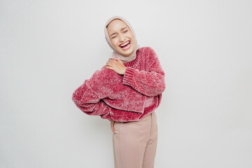 Tired upset young Asian Muslim woman suffering from back pain, muscle spasm at workplace. Fatigue,...