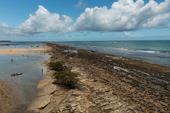 reefs between the beach and the sea at low tide