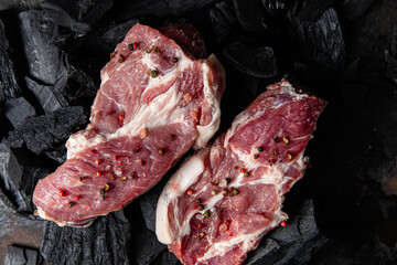 Raw pork steak on a dark background close-up