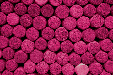 Wine corks background in Viva Magenta. Red top view. Color of the year 2023