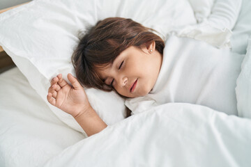 Fototapeta na wymiar Adorable hispanic girl lying on bed sleeping at bedroom