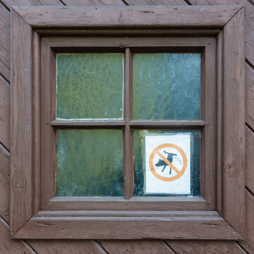 Schild an einer alten, hölzernen Türe: Hunde pinkeln verboten
