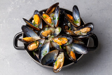 Delicious seafood mussels with parsley sauce and lemon. Delicious steamed mussels.