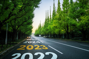 2023 New Year road trip travel and future vision concept . Nature landscape with highway road...
