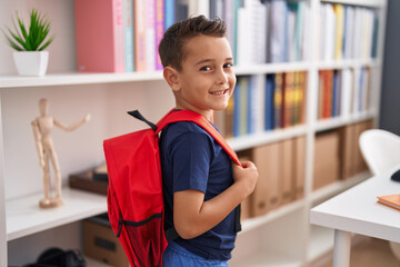 Adorable hispanic toddler student smiling confident standing at library school