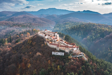 Aerial view with Rasnov fortress, the famous medieval landmark in Carpathian Mountain Brasov Romania