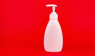 White bottle with a dispenser on a red background