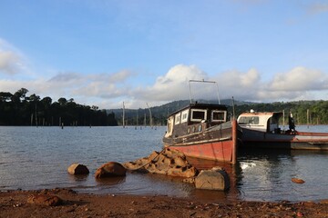 Brownsweg, Suriname. 14-10-2022 Brokopondo Reservoir. 2 ships docked at Ston Island. Dead trees are...