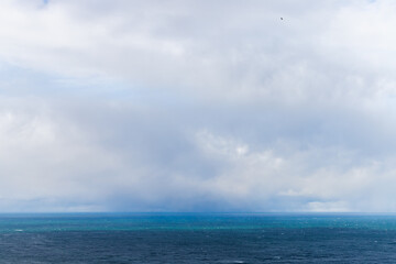 Naklejka na ściany i meble Blue Baltic Sea water is under cloudy sky on a c cloudy day