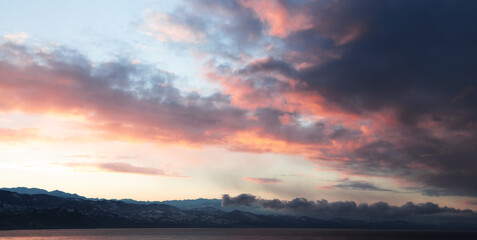 Coastal mountains under colorful sunrise sky