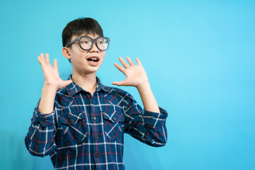 Children close up photo of cute and cheerful people, wearing glasses looking and smile on blue pastel background