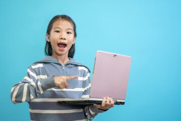 Children close up photo of cute and cheerful people, holding labtop looking and smile on blue pastel background