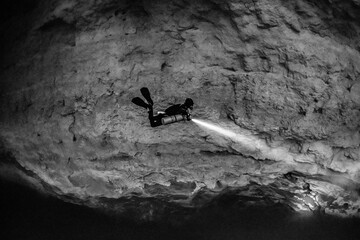 cave diver instructor leading a group of divers in a mexican cenote underwater
