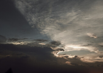 Obraz premium The sun's rays passing through the clouds and shining form an interesting light pattern against the sky. Space for text, Selective focus.