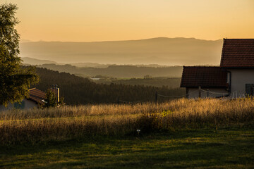house in landscape during sunset in the volcano mountains of the French region of the Auvergne in...
