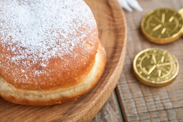 Happy Hanukkah. Hanukkah sweet doughnuts, gift boxes, white candles and chocolate coins on old  wooden background. Image and concept of jewish holiday Hanukkah. Top view.
