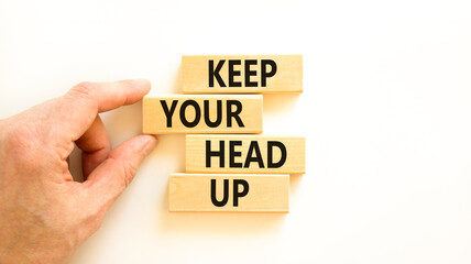 Keep your head up symbol. Concept words Keep your head up on wooden cubes. Beautiful white table white background. Businessman hand. Business motivational keep your head up concept. Copy space.