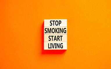 Stop smoking start living symbol. Concept words Stop smoking start living on cubes. Beautiful orange background. Medical healthy lifestyle stop smoking start living concept. Copy space.
